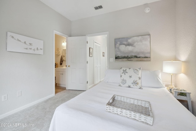 bedroom featuring light carpet, ensuite bath, visible vents, and baseboards