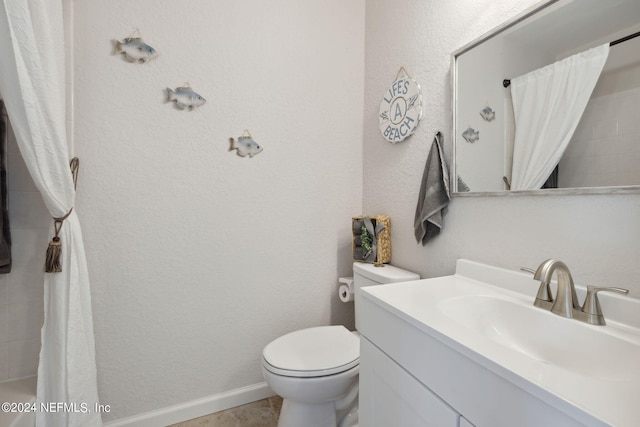 full bath with toilet, a textured wall, and vanity