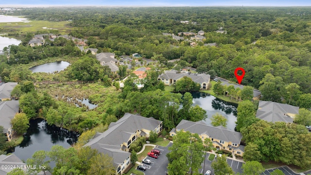 drone / aerial view with a water view, a forest view, and a residential view