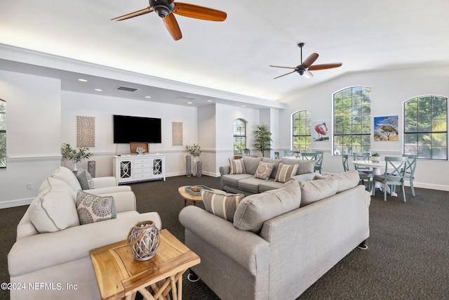 living room featuring a ceiling fan, dark colored carpet, visible vents, and lofted ceiling