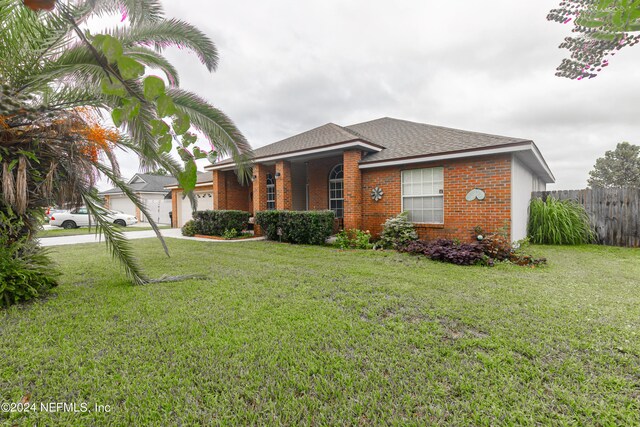 view of front facade with a front yard and a garage