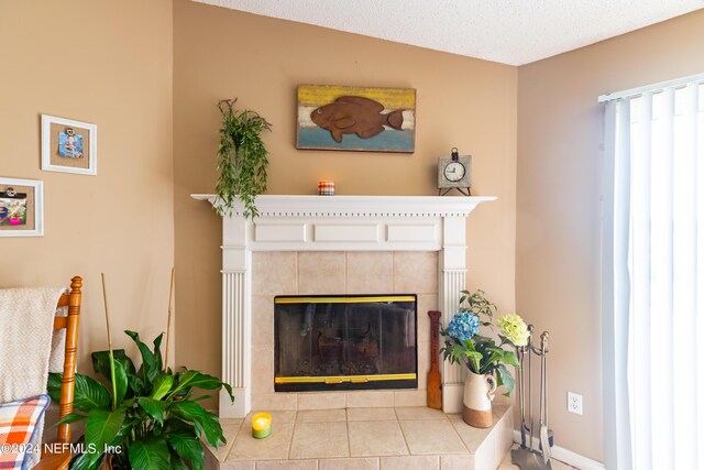 tiled living room featuring a textured ceiling, lofted ceiling, and a tiled fireplace