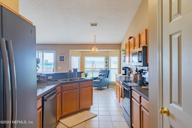 kitchen with a chandelier, a textured ceiling, sink, stainless steel appliances, and light tile patterned floors