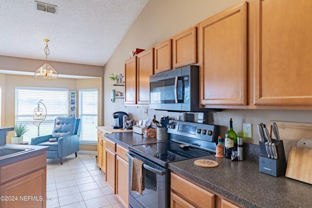 kitchen with appliances with stainless steel finishes, vaulted ceiling, pendant lighting, a textured ceiling, and an inviting chandelier