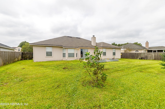 rear view of house with a lawn