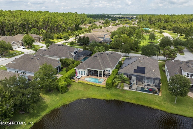 bird's eye view with a water view, a residential view, and a view of trees