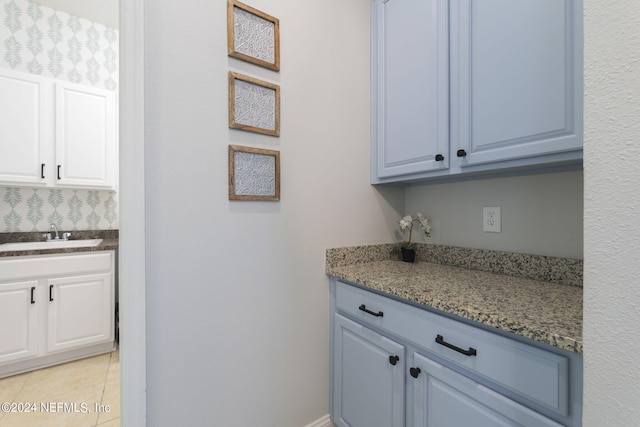 interior space with light tile patterned flooring and a sink