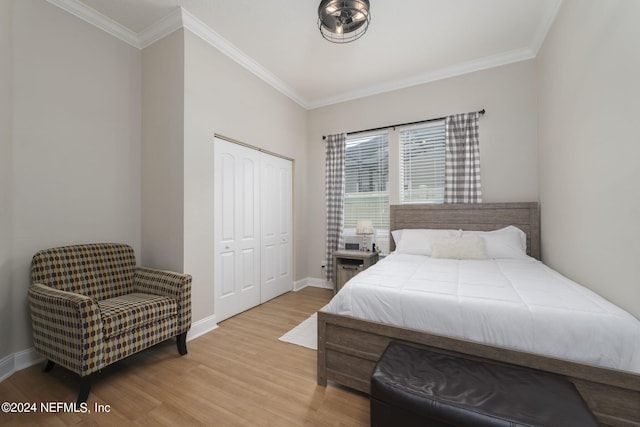 bedroom with light wood finished floors, baseboards, and ornamental molding