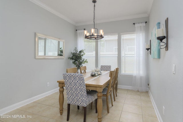 dining space featuring light tile patterned flooring, crown molding, baseboards, and an inviting chandelier