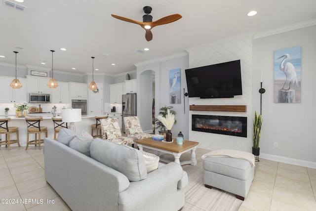 living room featuring visible vents, crown molding, and light tile patterned flooring