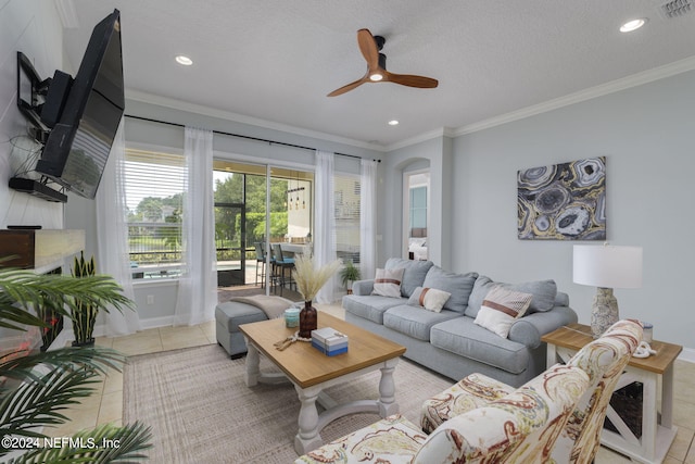 living area featuring visible vents, arched walkways, ornamental molding, tile patterned flooring, and a textured ceiling