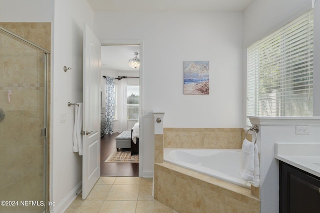 bathroom featuring tile patterned floors, a stall shower, connected bathroom, vanity, and a bath