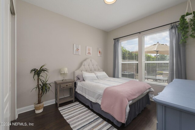 bedroom featuring baseboards and wood finished floors