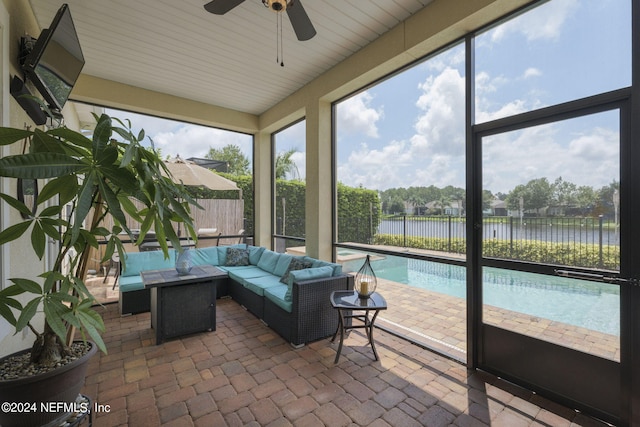 sunroom / solarium featuring a water view