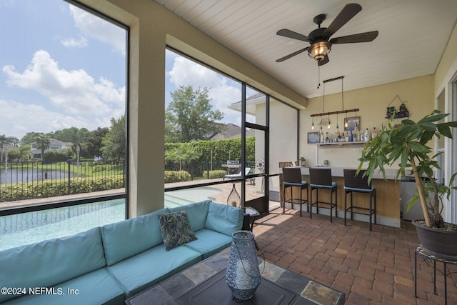 sunroom featuring a ceiling fan