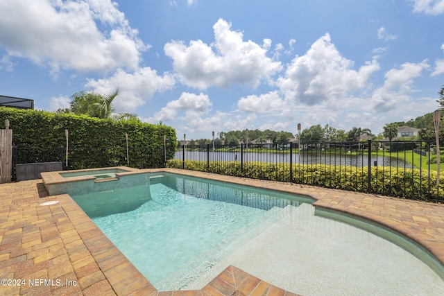 view of swimming pool with a pool with connected hot tub, fence, and a patio