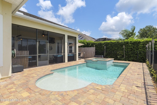 view of pool with a sunroom, a pool with connected hot tub, a fenced backyard, and a patio