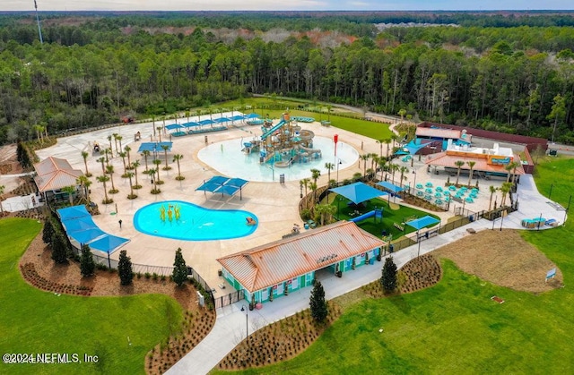 bird's eye view with a wooded view