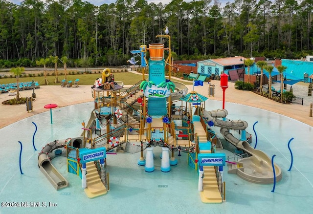 view of play area with a forest view