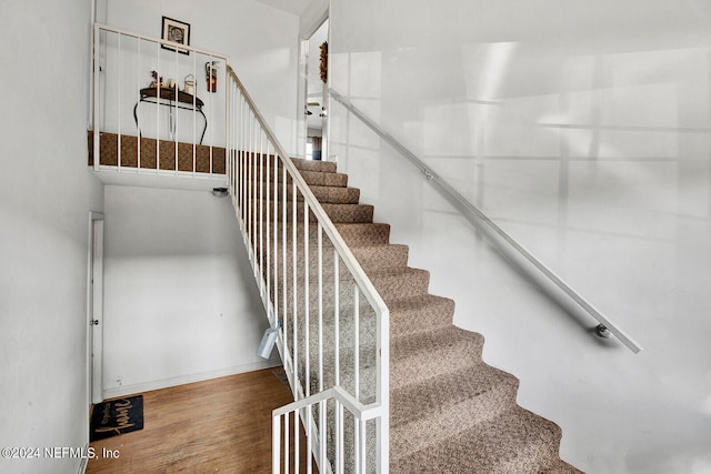 stairway featuring hardwood / wood-style flooring