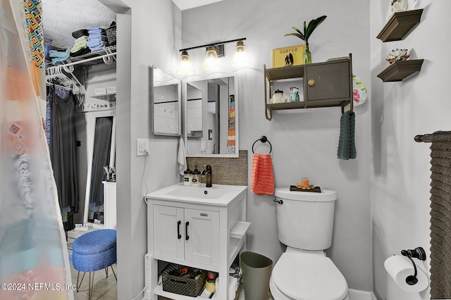 bathroom with toilet and vanity