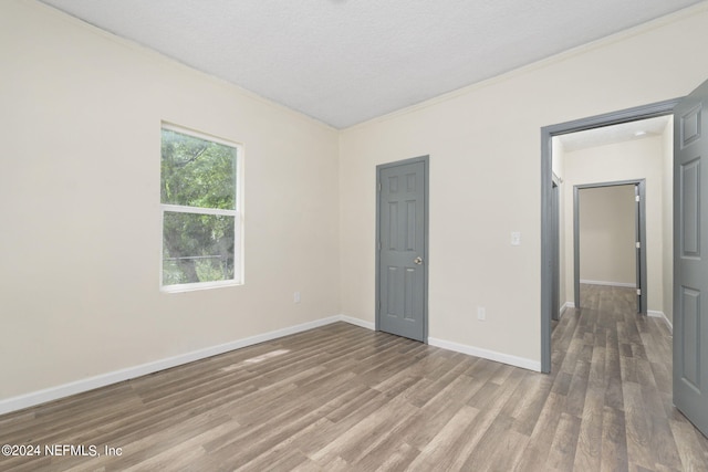 unfurnished bedroom featuring a textured ceiling and hardwood / wood-style flooring