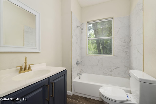 full bathroom featuring toilet, tiled shower / bath combo, and vanity