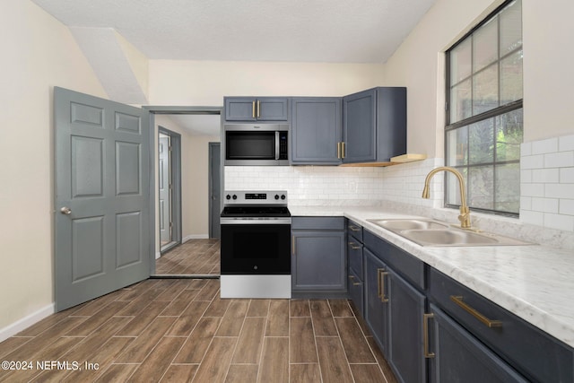 kitchen with a textured ceiling, dark hardwood / wood-style floors, tasteful backsplash, sink, and electric stove