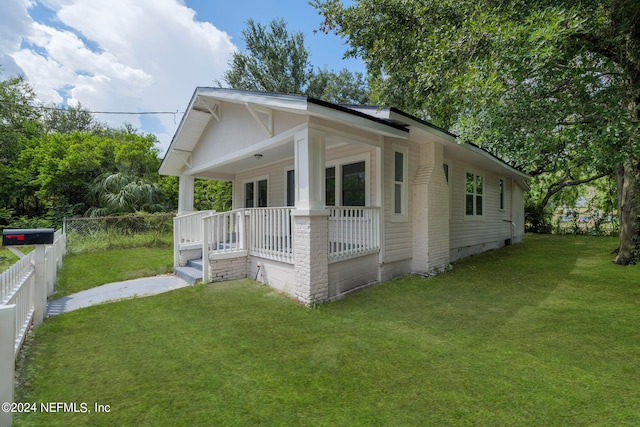 view of front of house featuring a front yard and covered porch