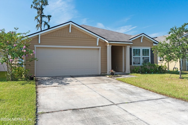 ranch-style home with driveway, an attached garage, and a front lawn