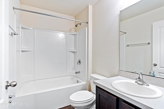 full bathroom featuring toilet, shower / tub combination, vanity, and a textured ceiling