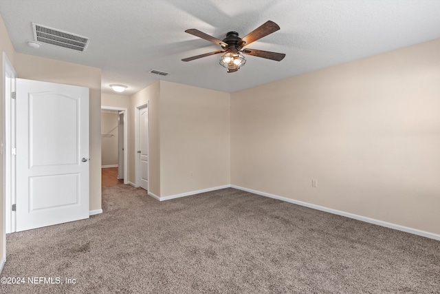 empty room featuring ceiling fan and carpet flooring