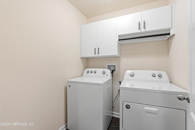 laundry area featuring cabinet space, washing machine and dryer, and baseboards