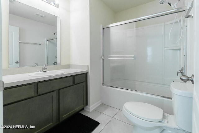 full bathroom featuring tile patterned flooring, vanity, toilet, and shower / bath combination with glass door