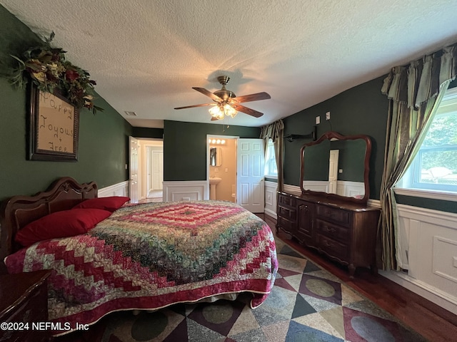 35095 Brandy Ln, Callahan, FL 32011 - bedroom featuring visible vents, wainscoting, ceiling fan, wood finished floors, and ensuite bathroom
