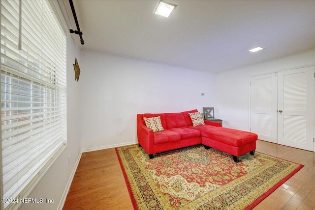 living area featuring wood finished floors and baseboards