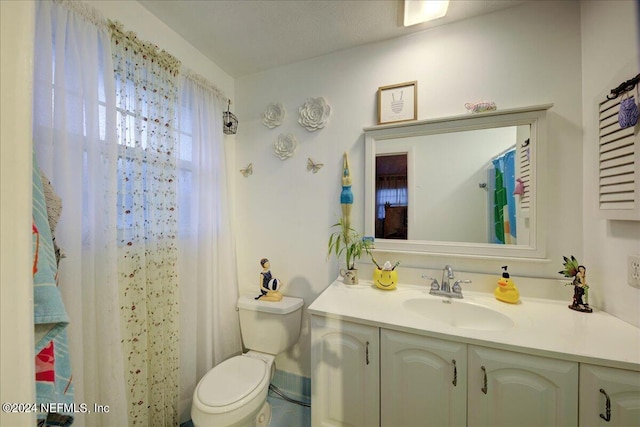 full bathroom with vanity and toilet