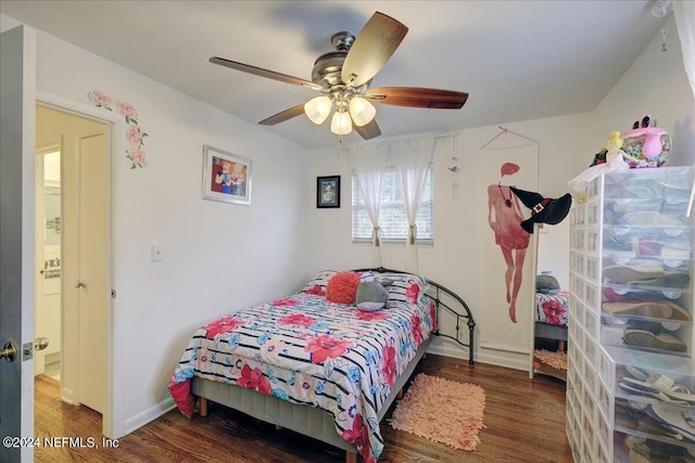 bedroom with ceiling fan, wood finished floors, and baseboards