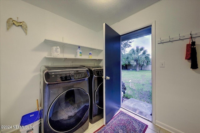 laundry area with laundry area, washer and dryer, and tile patterned floors