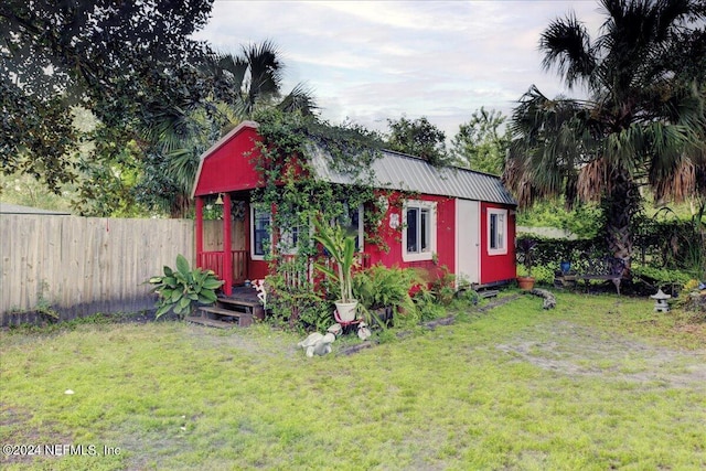 view of outbuilding with fence and an outdoor structure