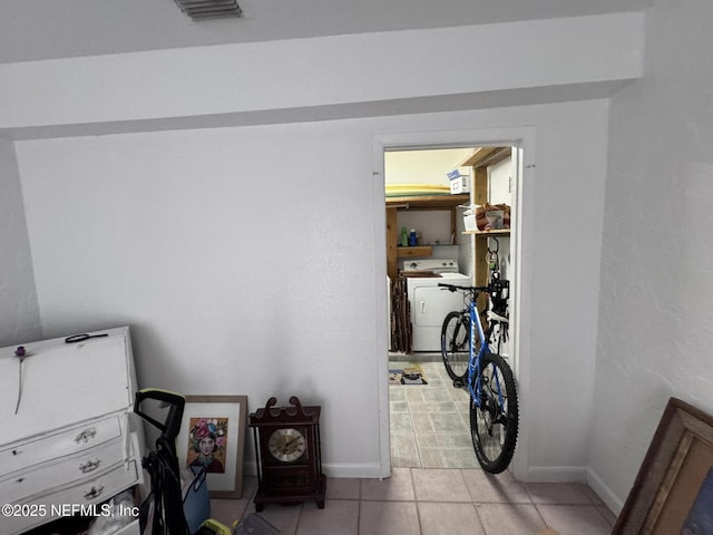 interior space with light tile patterned floors, visible vents, and baseboards