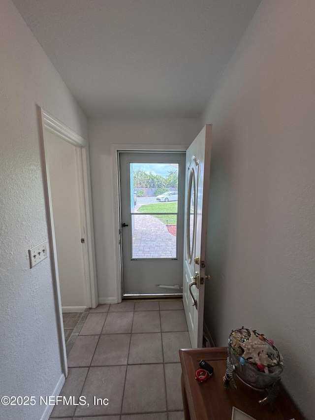 doorway to outside featuring light tile patterned floors