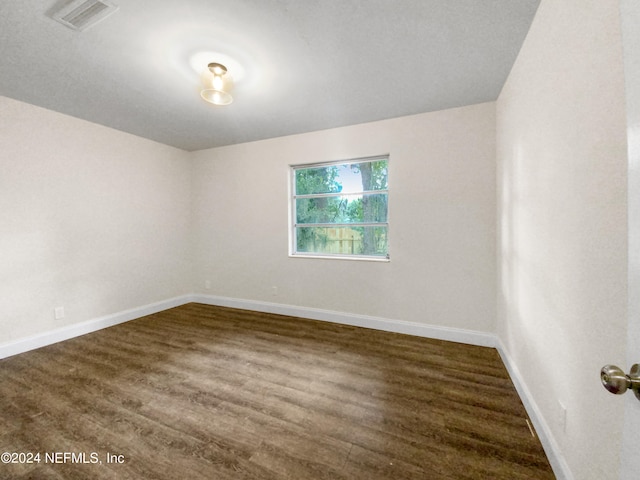 empty room with wood-type flooring