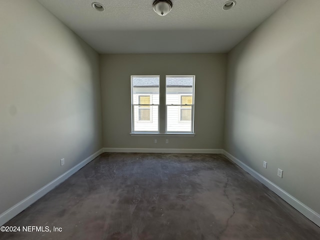 empty room featuring a textured ceiling