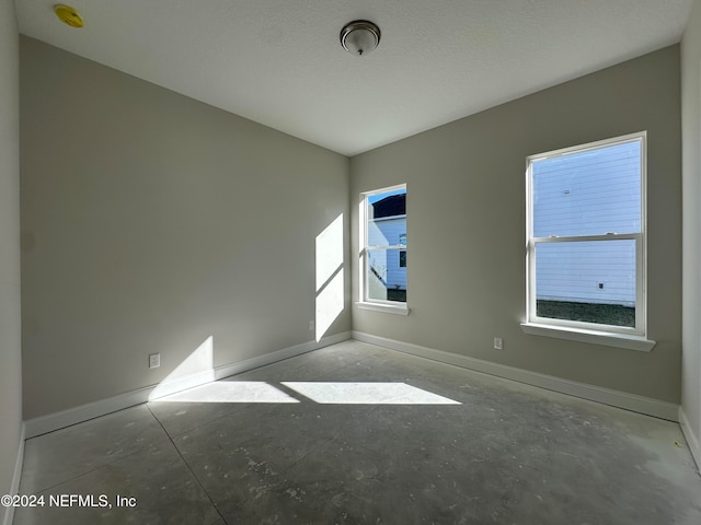 spare room with a healthy amount of sunlight and a textured ceiling