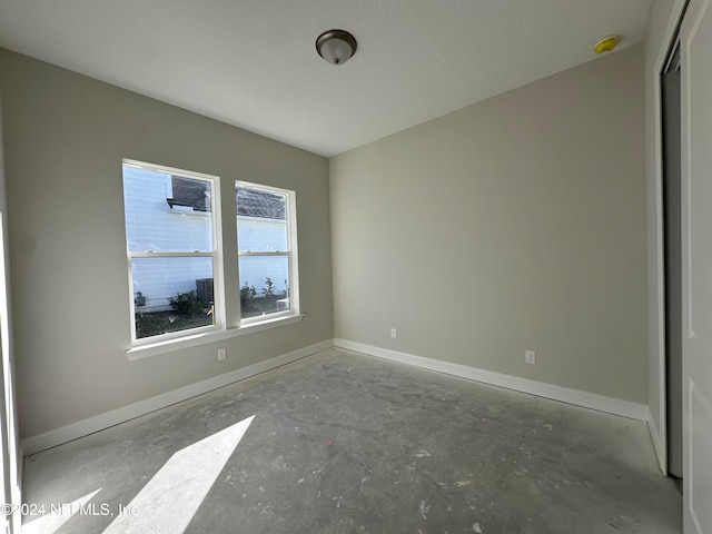 empty room with concrete flooring and a textured ceiling