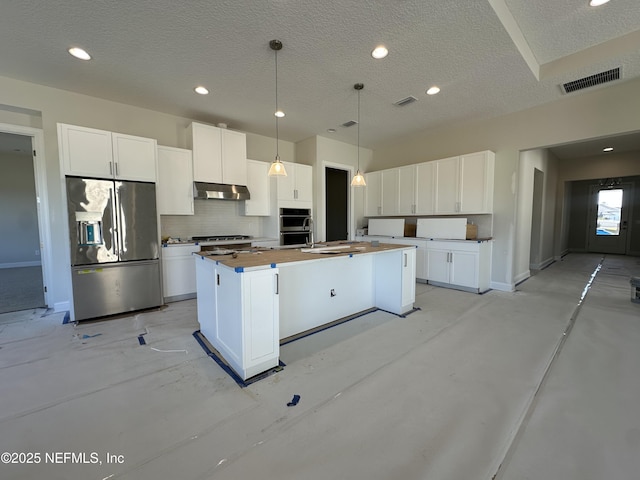 kitchen with under cabinet range hood, a center island with sink, appliances with stainless steel finishes, and white cabinets