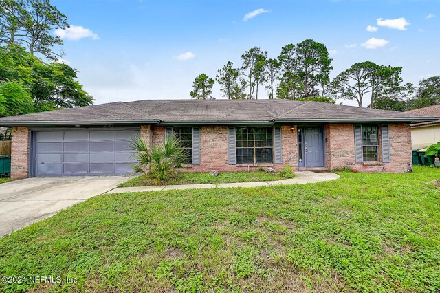 ranch-style house with a front lawn and a garage