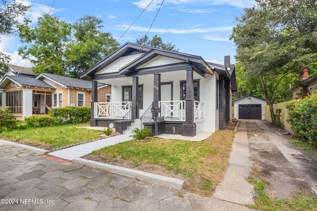 bungalow-style house with an outdoor structure, covered porch, and a garage