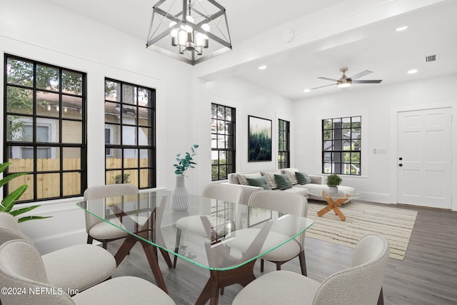 living room with hardwood / wood-style flooring and ceiling fan with notable chandelier